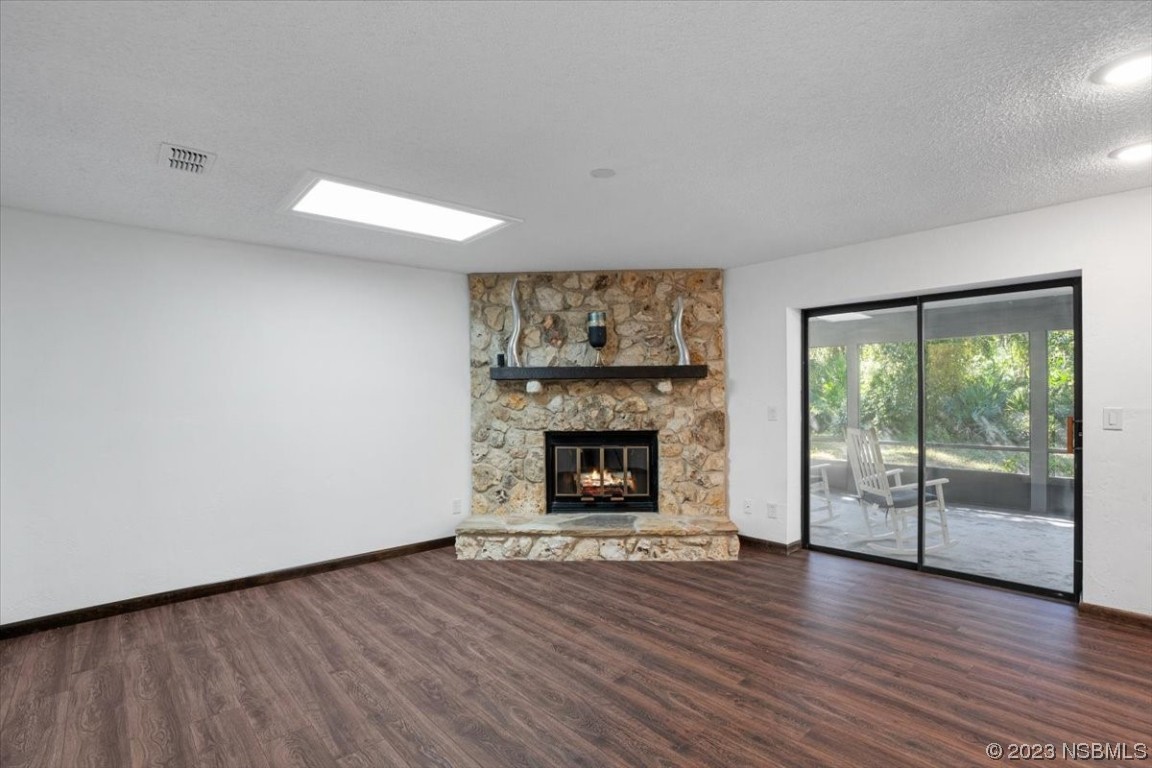 6202 Yellowstone Drive Port Orange, FL 32127 - Photo 16 of 34 wooden floor fireplace and natural light in room