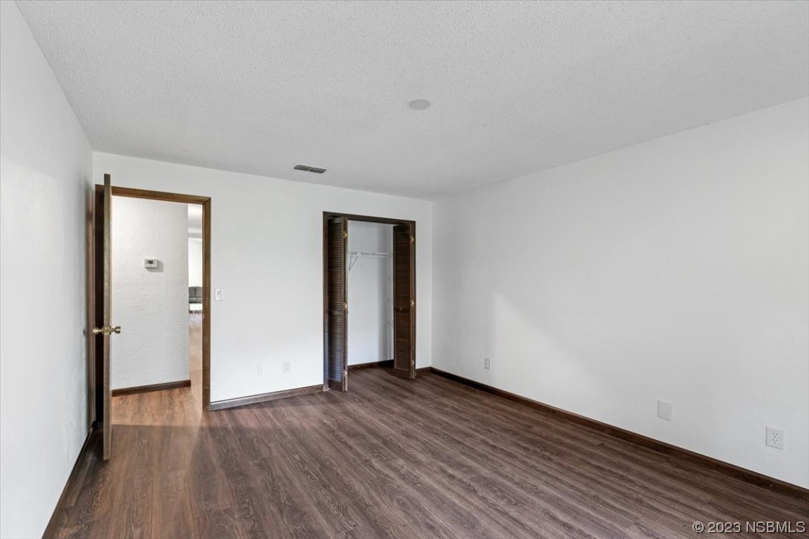 6202 Yellowstone Drive Port Orange, FL 32127 - Photo 23 of 34 a view of an empty room with wooden floor and closet