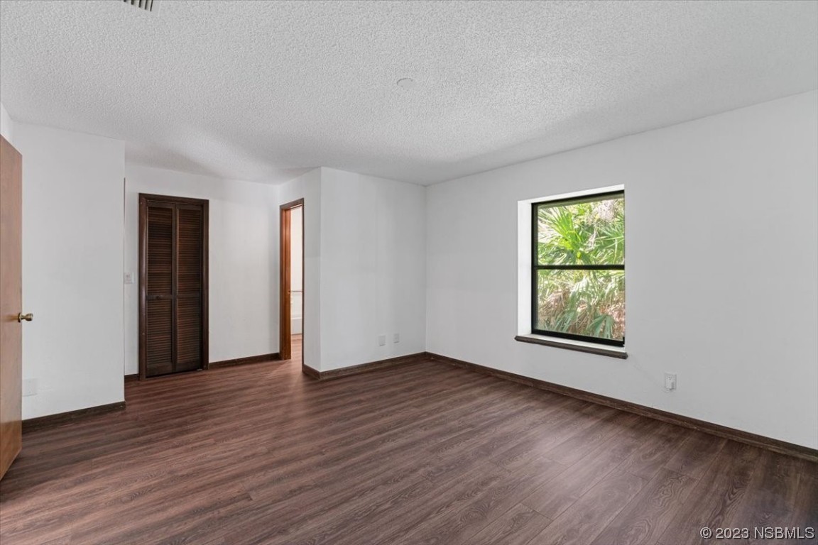 6202 Yellowstone Drive Port Orange, FL 32127 - Photo 28 of 34 an empty room with wooden floor and windows