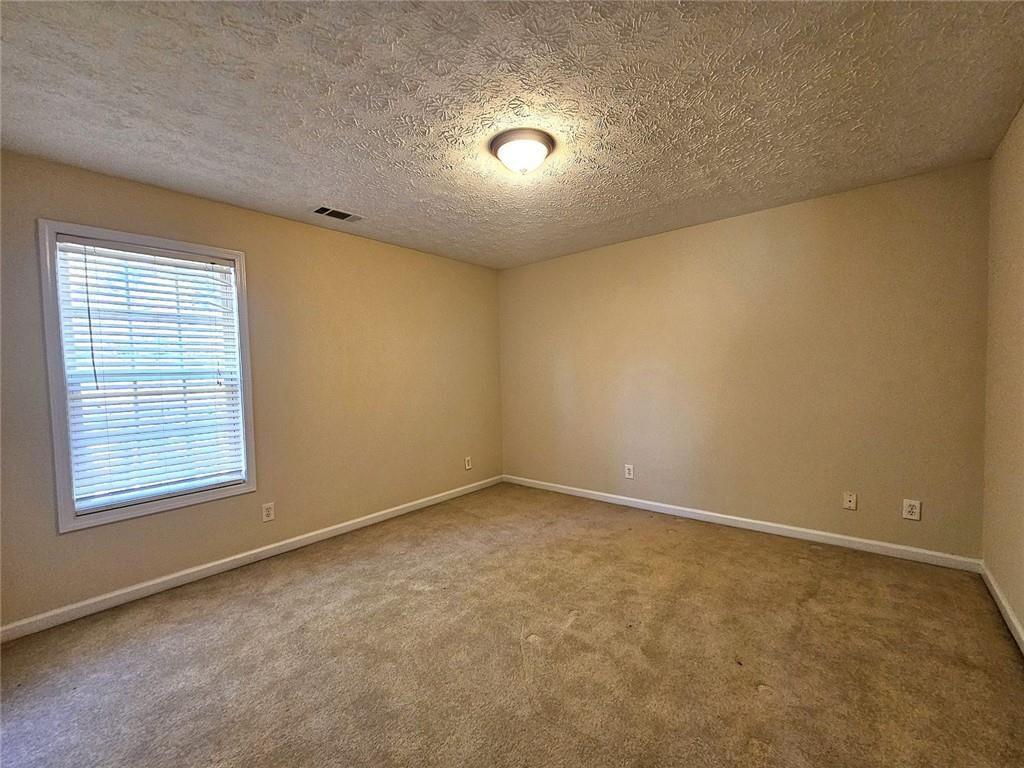 303 Apache Drive Canton, GA 30115 - Photo 12 of 19 an empty room with a empty space and windows