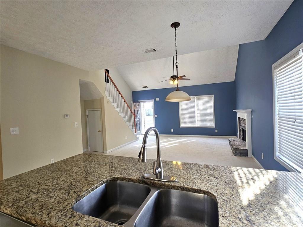 303 Apache Drive Canton, GA 30115 - Photo 3 of 19 a kitchen with a sink and a chandelier
