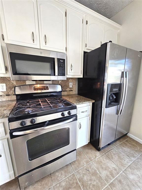 303 Apache Drive Canton, GA 30115 - Photo 5 of 19 a stove top oven sitting inside of a kitchen