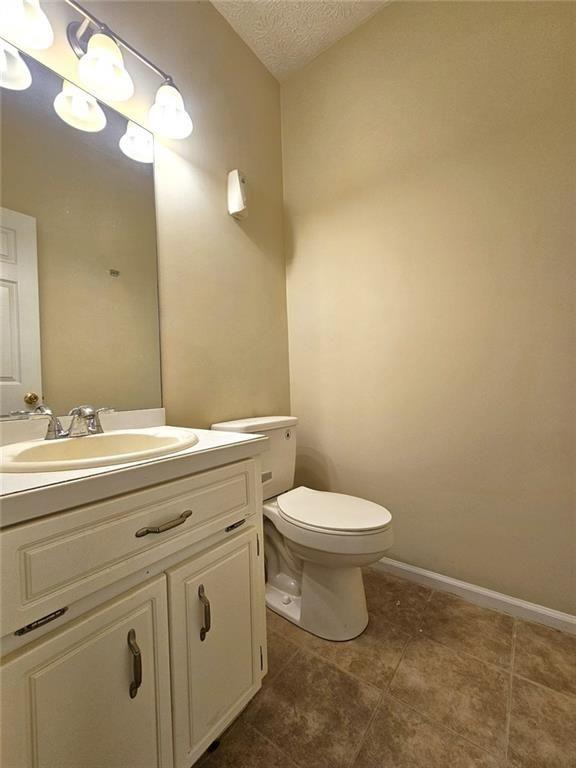 303 Apache Drive Canton, GA 30115 - Photo 7 of 19 a bathroom with a toilet sink and mirror