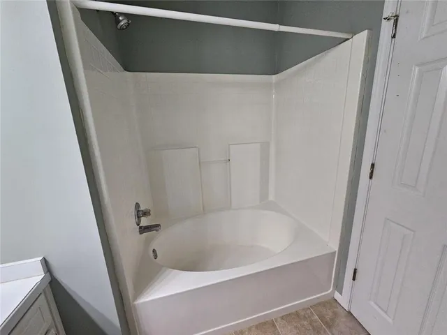 a white bath tub sitting in a bathroom