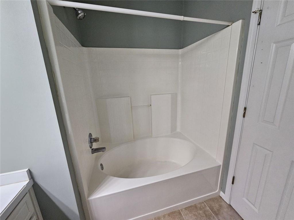 303 Apache Drive Canton, GA 30115 - Photo 9 of 19 a white bath tub sitting in a bathroom