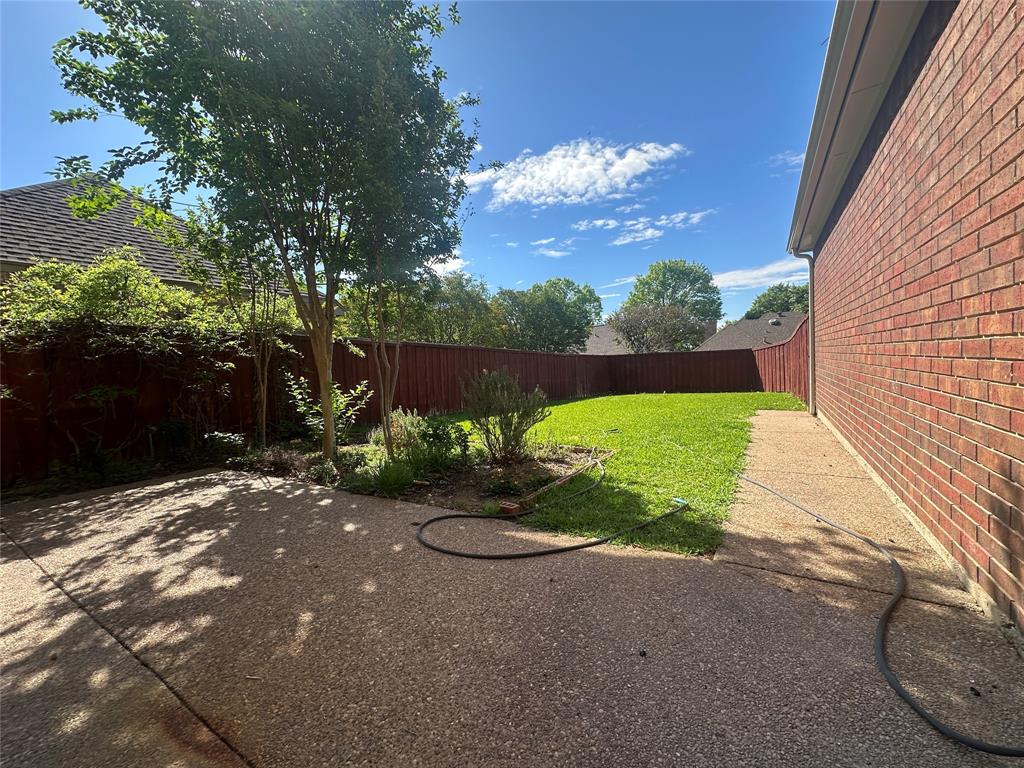 4342 Timberglen Road Dallas, TX 75287 - Photo 16 of 27 Fenced backyard with a patio