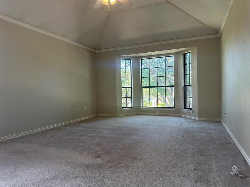 4342 Timberglen Road Dallas, TX 75287 - Photo 17 of 27 Unfurnished room with ornamental molding, lofted ceiling, carpet floors, and ceiling fan