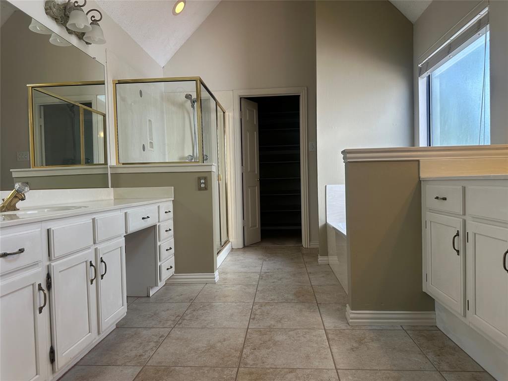 4342 Timberglen Road Dallas, TX 75287 - Photo 18 of 27 Bathroom featuring vanity, lofted ceiling, a shower stall, a bath, and a spacious closet