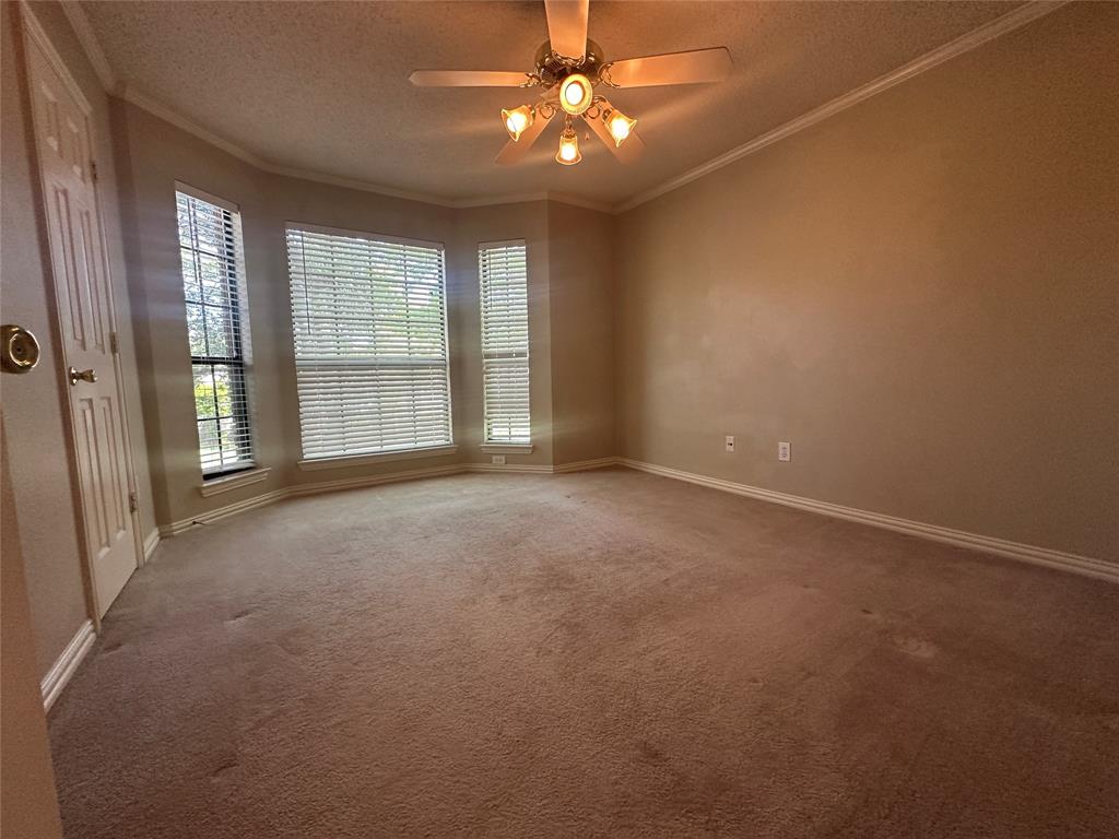 4342 Timberglen Road Dallas, TX 75287 - Photo 23 of 27 Unfurnished room with a ceiling fan, carpet floors, ornamental molding, and a textured ceiling