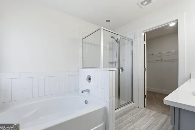 a bathroom with a bathtub and a shower