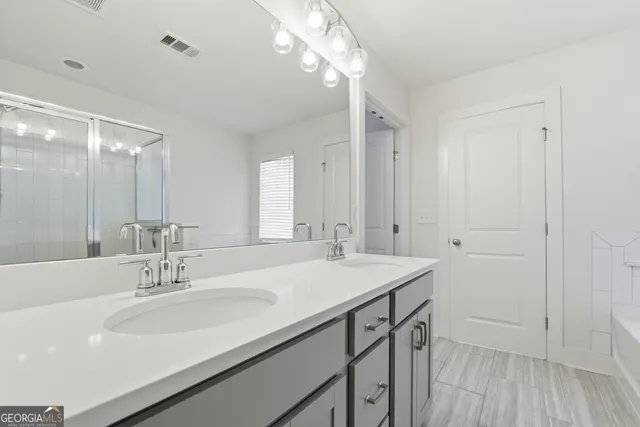 a bathroom with a sink a vanity and a mirror