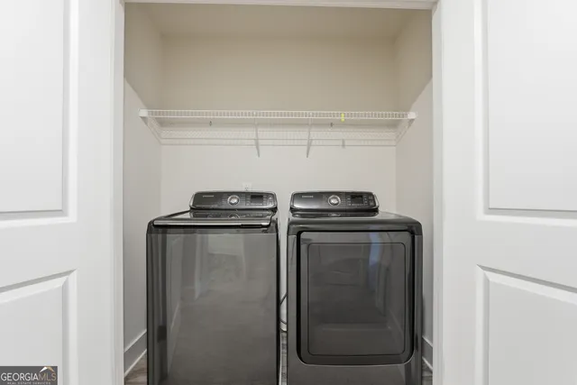 a view of storage and utility room with washer and dryer