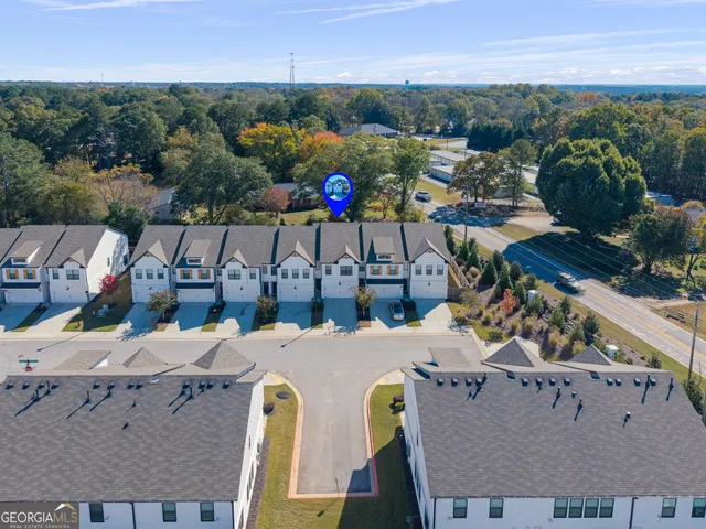 an aerial view of a house with a garden and lake view