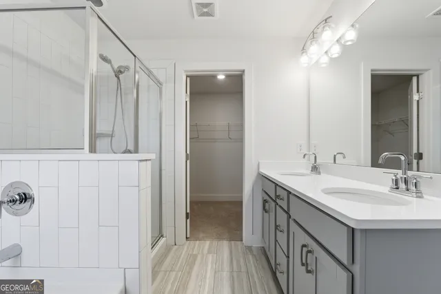a bathroom with a double vanity sink and a mirror