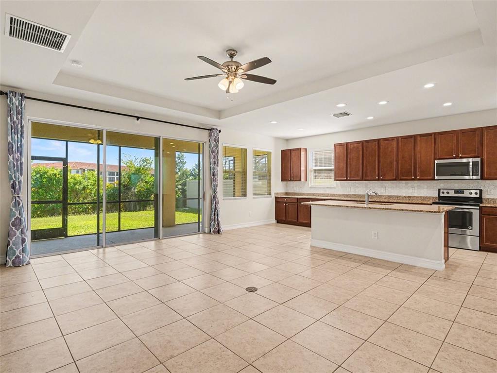 4429 Conchfish Lane Osprey, FL 34229 - Photo 3 of 20 a view of open kitchen with granite countertop a stove top oven a sink and a refrigerator