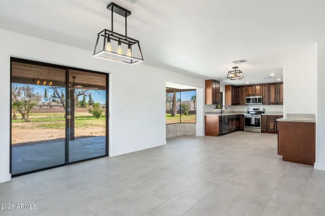 a kitchen with stainless steel appliances granite countertop a stove refrigerator sink and cabinets
