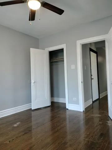 an empty room with wooden floor and natural light