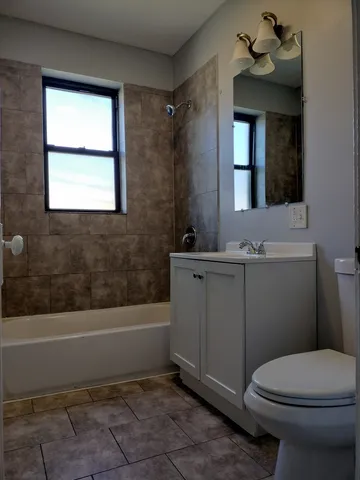 a bathroom with a sink a toilet and bathtub