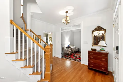 a bedroom with a bed and a flat tv screen on dresser