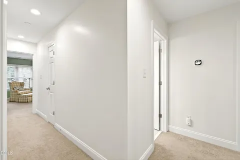 a bedroom with a bed mirror and window