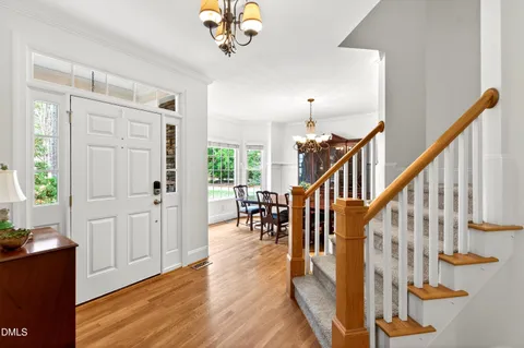 a view of an entryway with wooden floor and a livingroom view