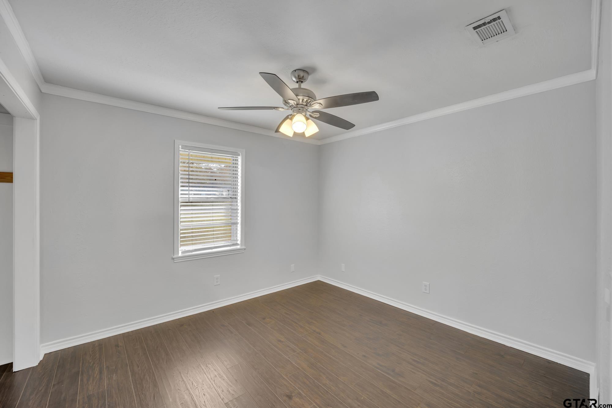 3743 Smelley Road Longview, TX 75605 - Photo 14 of 25 an empty room with wooden floor and windows
