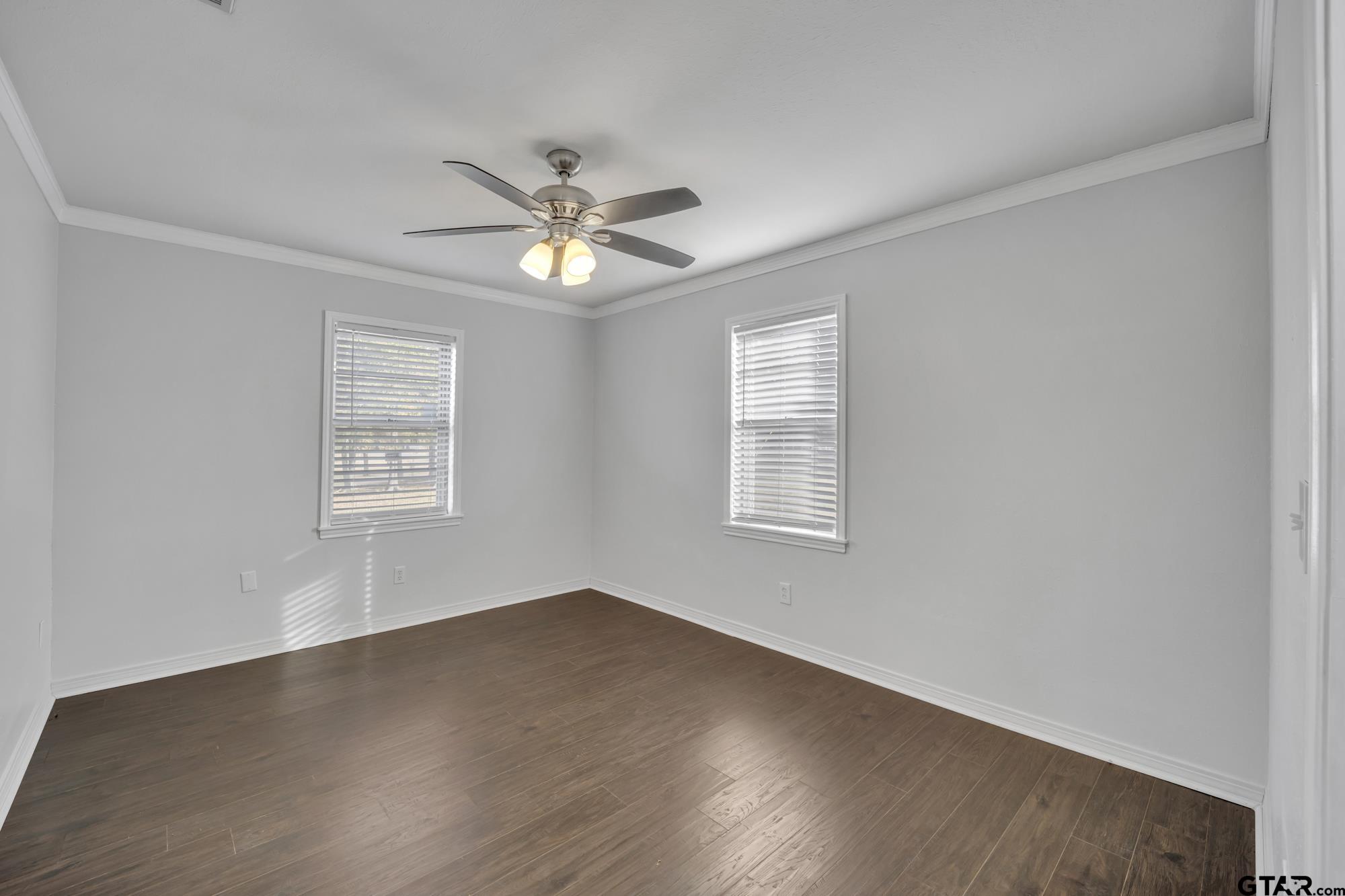 3743 Smelley Road Longview, TX 75605 - Photo 16 of 25 wooden floor in an empty room with a window