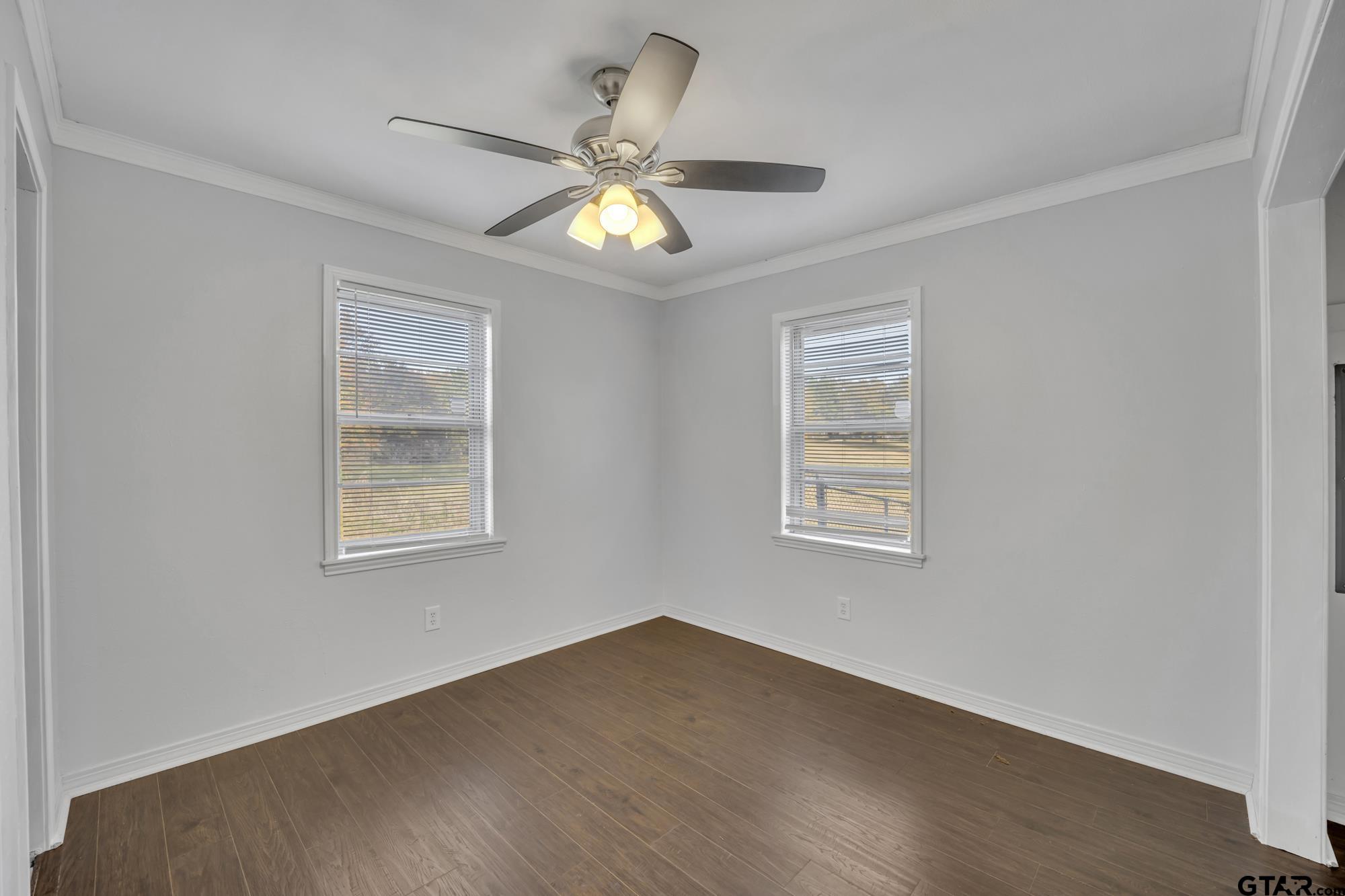 3743 Smelley Road Longview, TX 75605 - Photo 17 of 25 a view of an empty room with a window and wooden floor