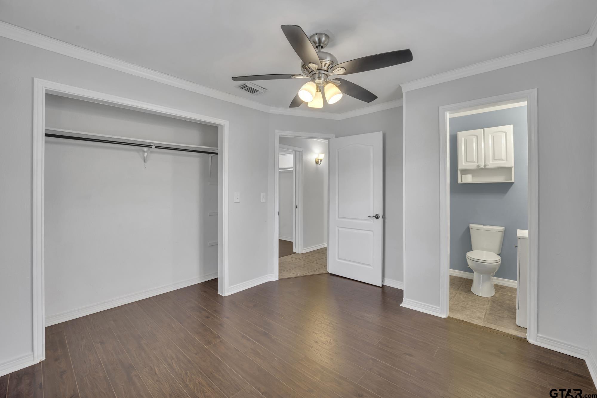 3743 Smelley Road Longview, TX 75605 - Photo 18 of 25 a view of a room with wooden floor and a ceiling fan