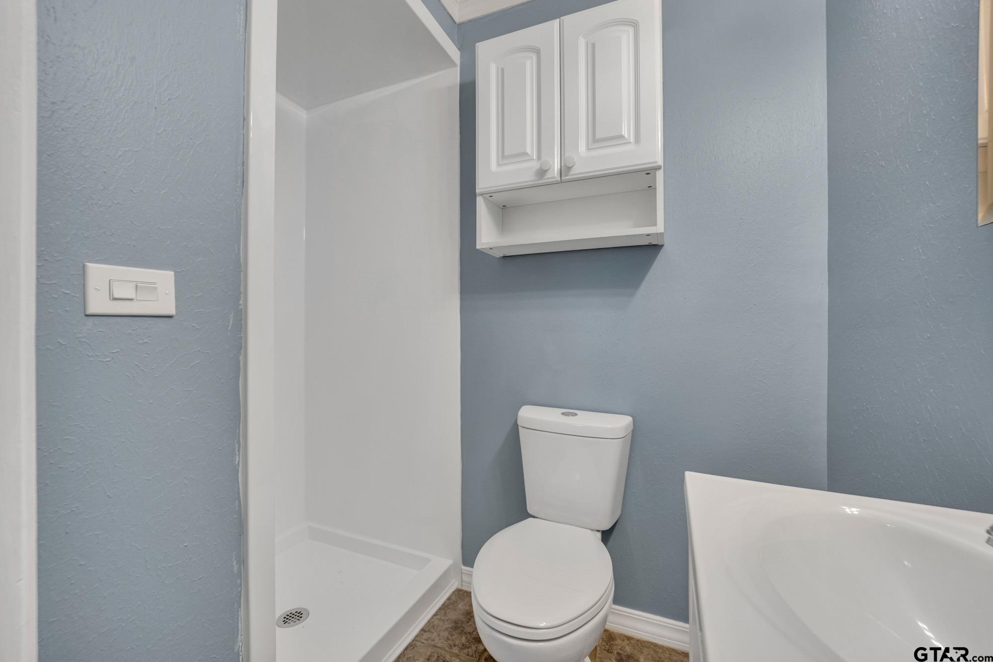 3743 Smelley Road Longview, TX 75605 - Photo 20 of 25 a white toilet sitting next to a bathroom sink