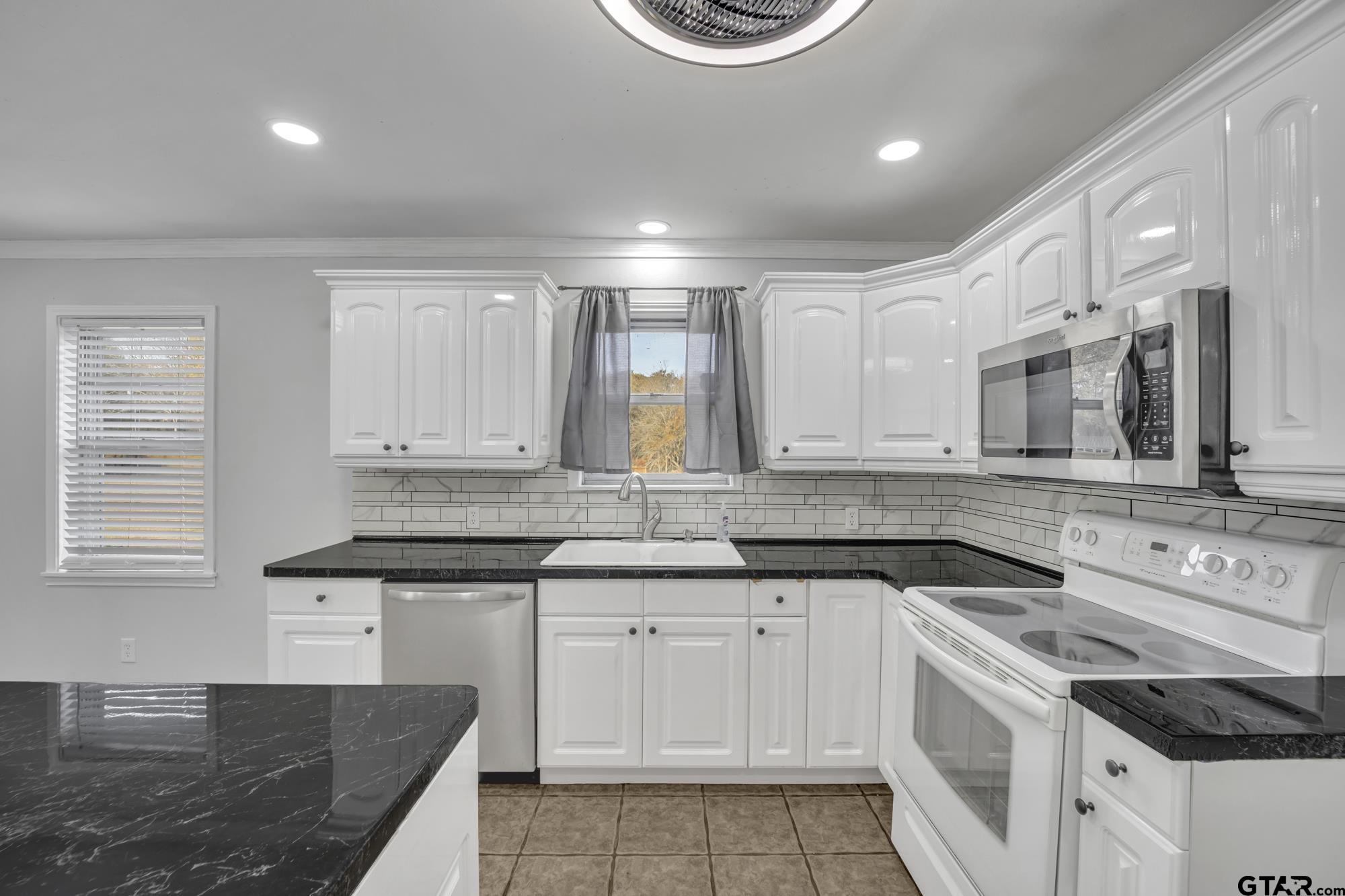 3743 Smelley Road Longview, TX 75605 - Photo 4 of 25 a kitchen with a sink stove and cabinets