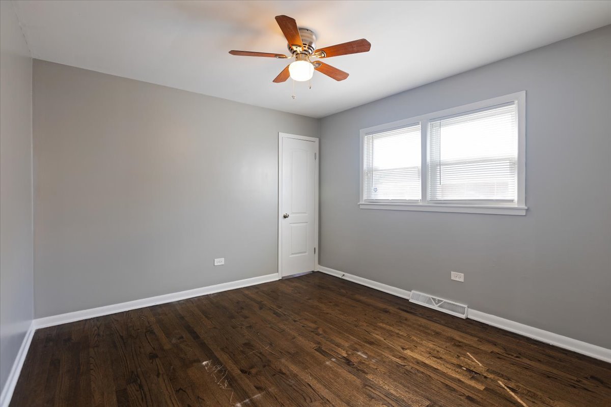 15304 Grant Street Dolton, IL 60419 - Photo 13 of 32 wooden floor in an empty room with a window
