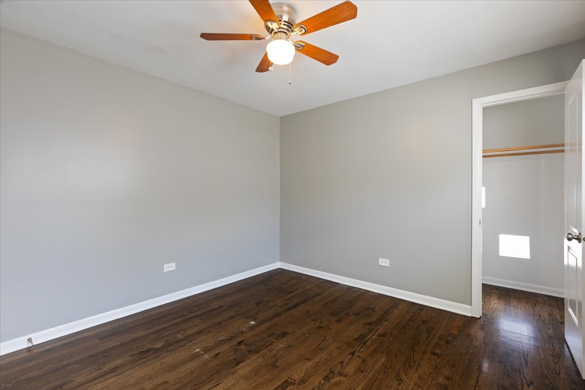 15304 Grant Street Dolton, IL 60419 - Photo 14 of 32 a view of an empty room with window and wooden floor