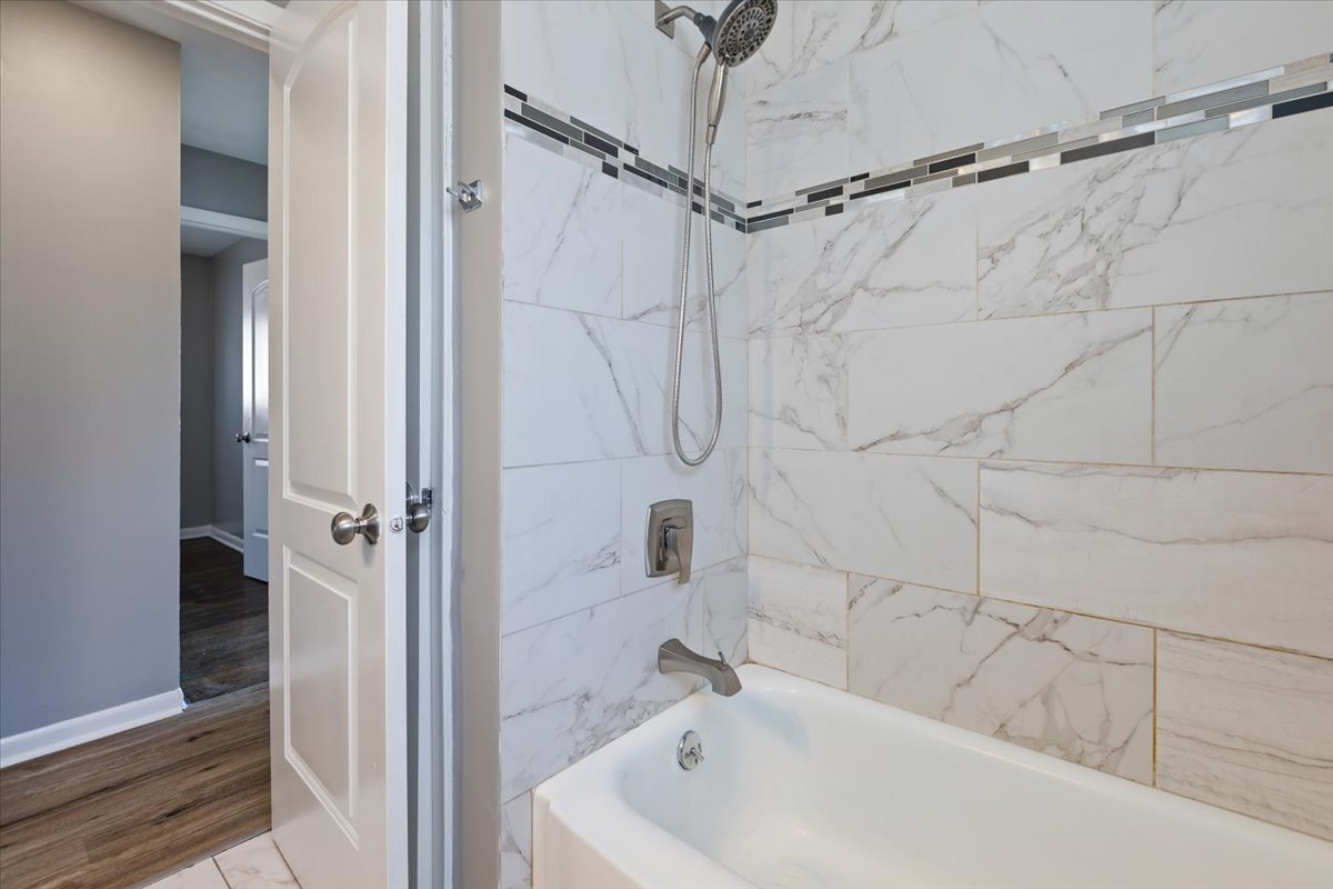 15304 Grant Street Dolton, IL 60419 - Photo 16 of 32 a bathroom with a white bath tub and a shower