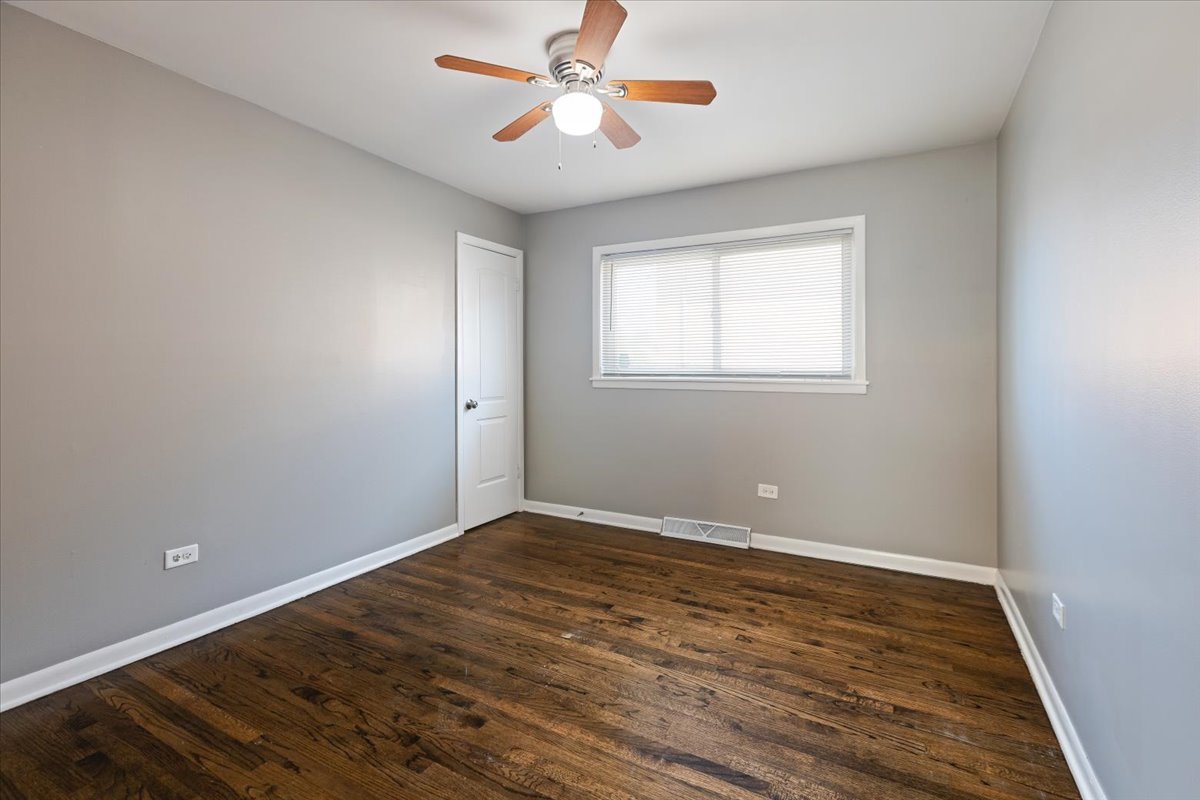 15304 Grant Street Dolton, IL 60419 - Photo 19 of 32 wooden floor in an empty room with a window
