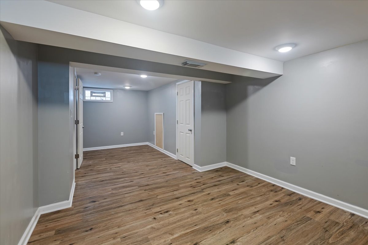 15304 Grant Street Dolton, IL 60419 - Photo 25 of 32 a view of an empty room with wooden floor and a window
