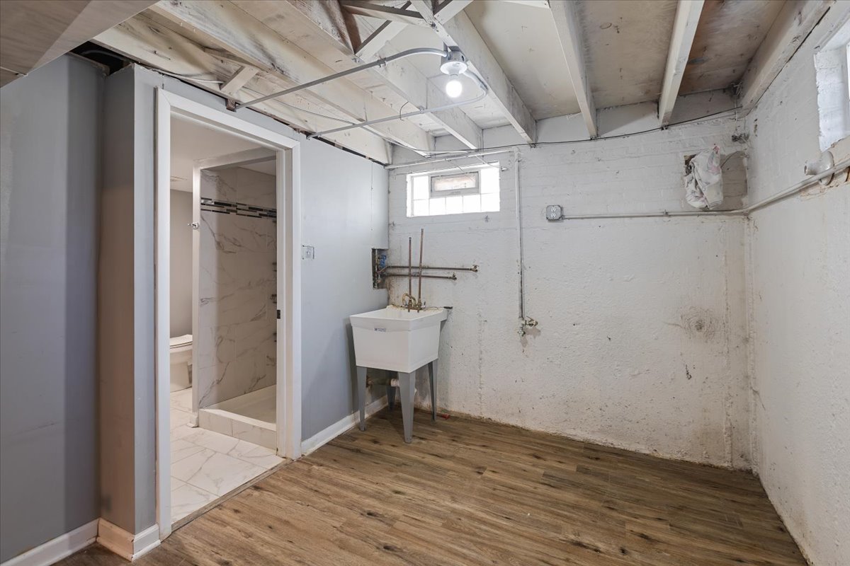 15304 Grant Street Dolton, IL 60419 - Photo 28 of 32 a view of a hallway with wooden floor and a bathroom