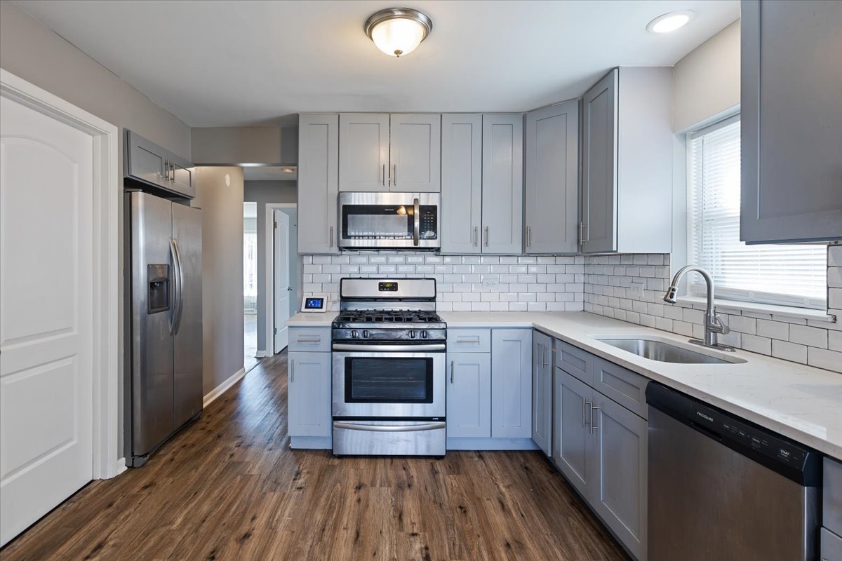 15304 Grant Street Dolton, IL 60419 - Photo 10 of 32 a kitchen with a sink dishwasher a refrigerator and a stove top oven