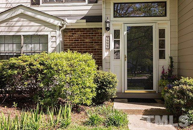7777 Falcon Rest Circle Raleigh, NC 27615 - Photo 2 of 24 a front view of a house with a garden