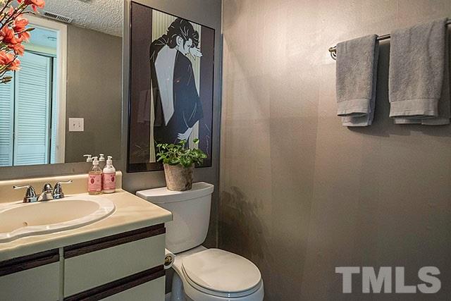 7777 Falcon Rest Circle Raleigh, NC 27615 - Photo 13 of 24 a bathroom with a sink toilet and a mirror