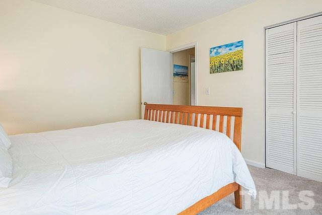 7777 Falcon Rest Circle Raleigh, NC 27615 - Photo 15 of 24 a bedroom with a bed and painting on the wall