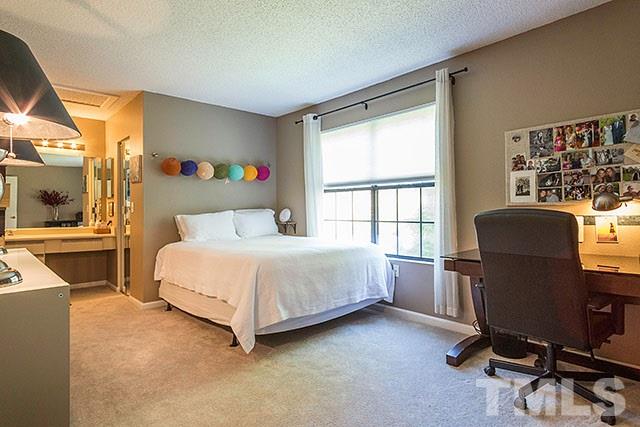 7777 Falcon Rest Circle Raleigh, NC 27615 - Photo 17 of 24 a bed room with a bed and a chair