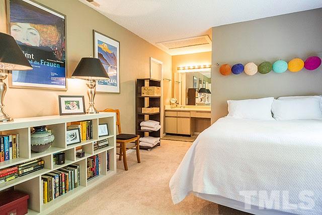 7777 Falcon Rest Circle Raleigh, NC 27615 - Photo 18 of 24 a bedroom with a bed and a book shelf
