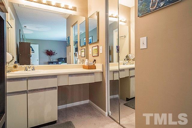 7777 Falcon Rest Circle Raleigh, NC 27615 - Photo 20 of 24 a bathroom with a double vanity sink and mirror