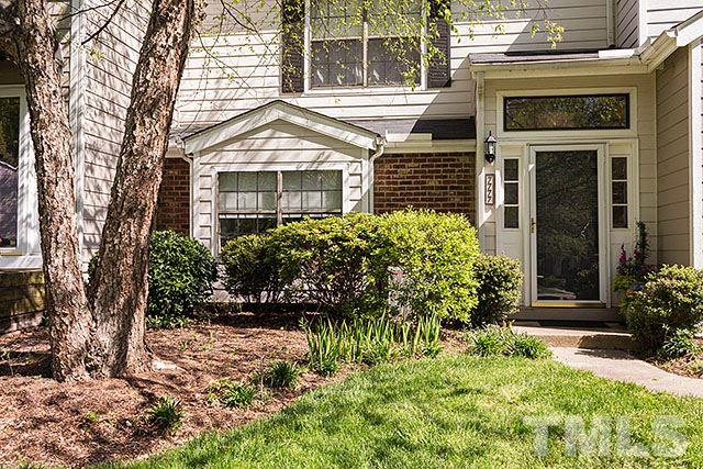 7777 Falcon Rest Circle Raleigh, NC 27615 - Photo 3 of 24 a front view of a house with a yard and potted plants
