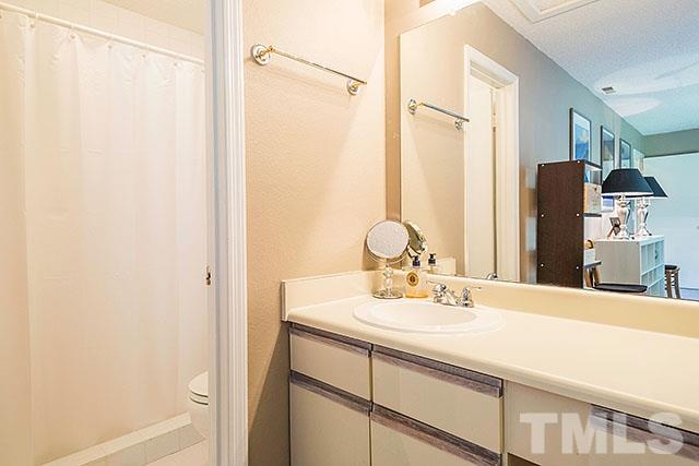 7777 Falcon Rest Circle Raleigh, NC 27615 - Photo 21 of 24 a bathroom with a double vanity sink and a mirror