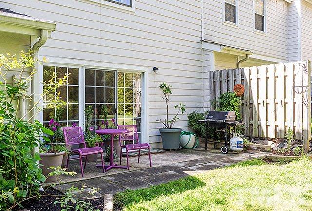 7777 Falcon Rest Circle Raleigh, NC 27615 - Photo 22 of 24 a view of a patio with table and chairs and potted plants