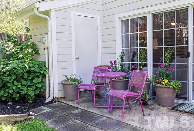 7777 Falcon Rest Circle Raleigh, NC 27615 - Photo 23 of 24 a view of a chair and table in the back yard of the house