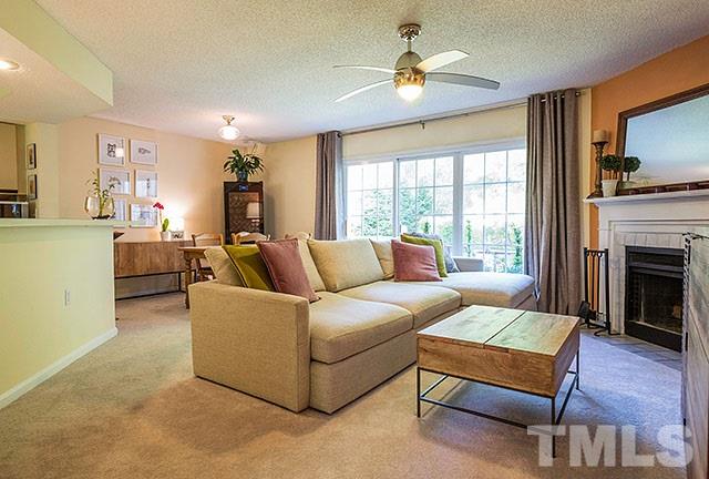 7777 Falcon Rest Circle Raleigh, NC 27615 - Photo 4 of 24 a living room with furniture fireplace and a flat screen tv