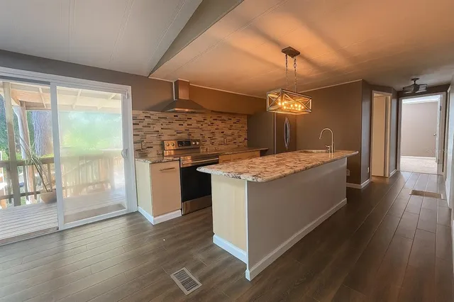 a kitchen with a stove sink and refrigerator